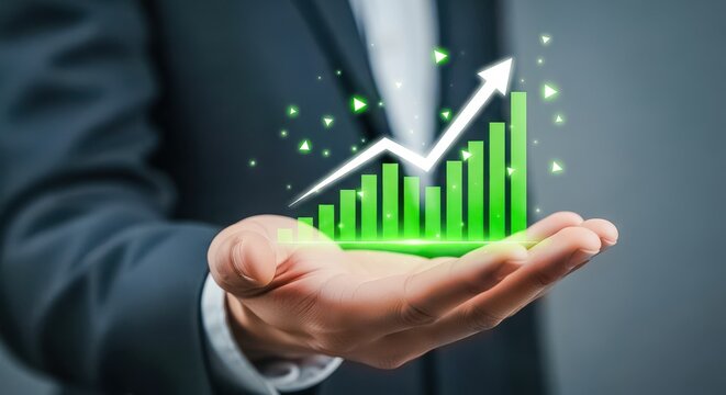 Businessman holding a glowing green financial growth chart with an upward arrow and sparkling particles