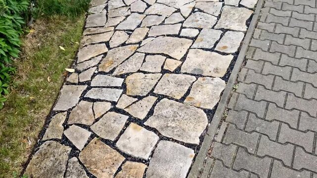 natural paving of flat stones in the shape of an arch. natural terrace near the house. cracks pattern in a crescent