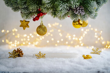 Christmas Holiday background with snow, fir tree and decorations with christmas light behind....