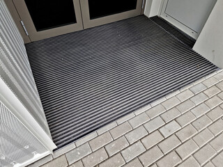 entrance tower block house. office building with wooden pergola. cleaning mat flush with boards....