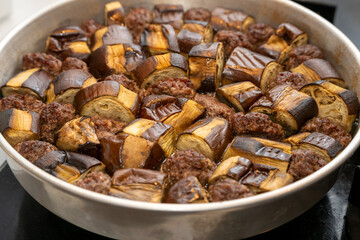 Homestyle eggplant and meatball stew cooked in a metal pot