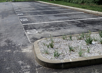 concrete barriers to protect a nice lawn cubes on a paved sidewalk. Undisciplined drivers cannot...