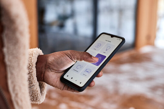 Man locking door using home automation app on smart phone