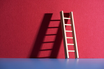 step ladder lening against red background