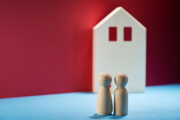 Wooden human couple  starts a life together with the property real estate investment concept