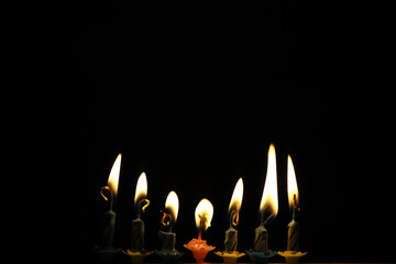 Lit Candles in a Dark Background for Celebrations and Religious Festivals