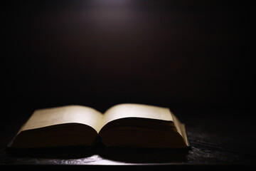 Open Book on Dark Background with Ambient Light - Symbol of Knowledge, Learning, Mystery