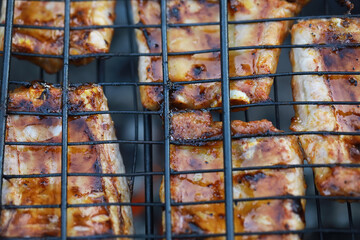 Grilled Barbecue Ribs Cooking on an Open Flame with Char Marks