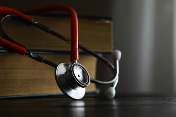 Stethoscope and Medical Books on Wooden Table - Symbol of Medical Education and Healthcare