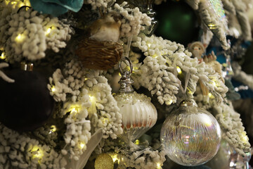 Christmas Tree Close-Up with Ornaments, Lights, and Snowy Branches