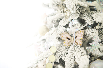 Elegant Frosted Christmas Tree with Butterfly Ornaments and Snowy Decor
