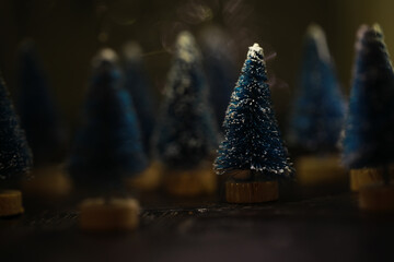 Blue Miniature Christmas Trees with Snowy Tips in Soft Focus Background