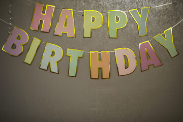 Colorful Happy Birthday Banner with Golden Edges on a Textured Background