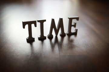 TIME Text Letters on Wooden Surface Representing Concept of Time Management and Planning