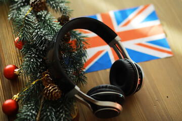 Christmas Holiday Music Scene with Headphones and British Flag on Rustic Wooden Table