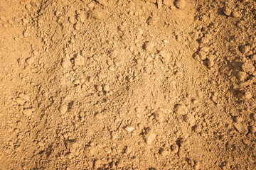 A detailed closeup image showing a cracked piece of dirt soil