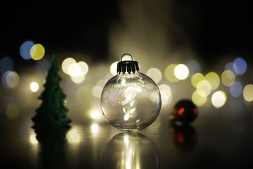 Festive Holiday Christmas Decoration with Glass Bauble, Bokeh Lights, and Mini Tree