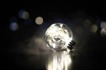 Close-up of Illuminated Glass Ball with Fairy Lights on Dark Background