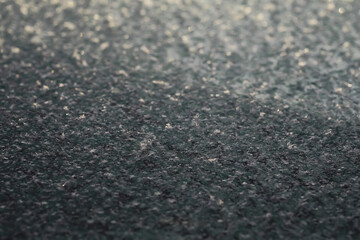 Close-Up of Frosty Surface with Sparkling Ice Crystals in Cold Winter Morning Light