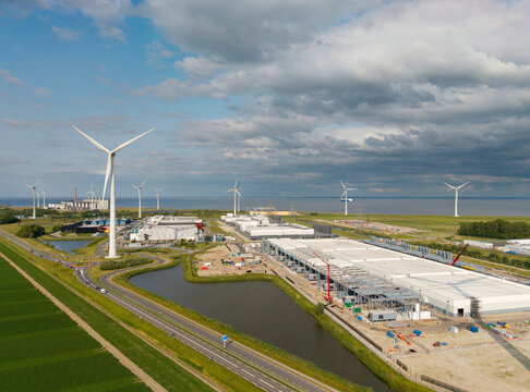Aerial view of datacenter construction in Eemshaven with turbines