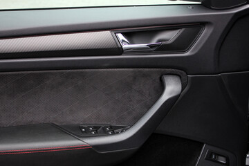 Luxury car door trims. Amazing interior. Front door panel. Inside car door. Interior handle in car interior.