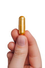 A person holds a shiny gold capsule between their fingers. Png, Transparent background.