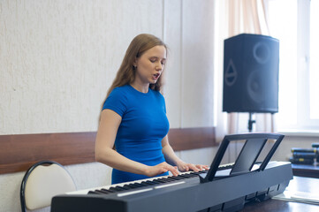 Caucasian woman playing electric piano. 