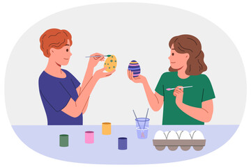 Children paint easter eggs in preparation for main christian holiday, standing at table with gouache and brushes. Celebrations easter in orthodox and catholic culture, on day of resurrection jesus