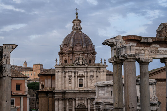 Fototapeta Rome, Italy: The ancient Roman forum with ancient temples and catholic churches in Rome, Italy capital city.