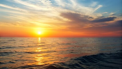 Fototapeta premium Vibrant Sunset Over Ocean with Reflective Waves and Orange Sky