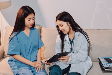 A doctor uses a stethoscope to check the heartbeat of his patient. Patients must undergo a yearly...