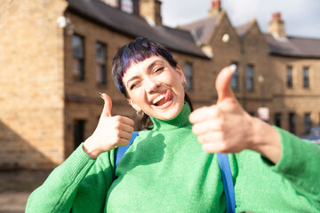 Cheerful young woman enjoying outdoor time at a historic stone building in an urban setting