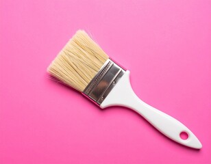 Paintbrush with soft blonde hair bristles on pink background