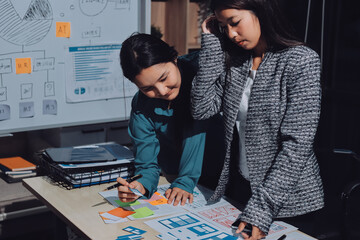 Group of young application developers analyzing uxui mobile app templates during a working meeting