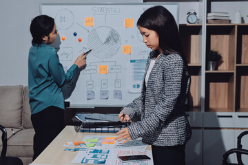 Group of young application developers analyzing uxui mobile app templates during a working meeting