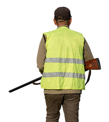 Mature man hunter with gun while walking on field.
