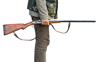 Mature man hunter with gun while walking on field.