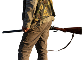 Mature man hunter with gun while walking on field.