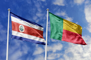 3D illustration. Costa Rica and Benin flags waving in the sky. High detailed waving flag. 3D render. Flags fluttered in the cloudy sky, symbolizing diplomatic relations.