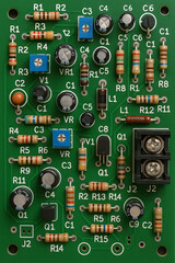 High-Density PCB with Green Solder Mask and White Silkscreen Featuring Through-Hole Components

