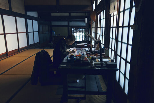伝統的な日本寺院で御朱印を綴る僧侶