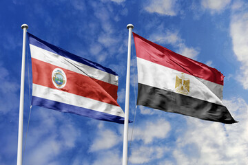 3D illustration. Costa Rica and Egypt  flags waving in the sky. High detailed waving flag. 3D render. Flags fluttered in the cloudy sky, symbolizing diplomatic relations.