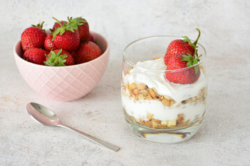 Strawberry Parfait with Yogurt and Granola with a bowl of fresh strawberries