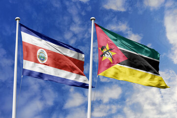 Costa Rica and Mozambique flags proudly waving against a vibrant blue sky, symbolizing...