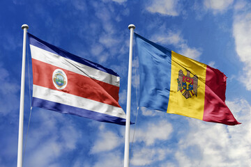 Costa Rica and Moldova flags proudly waving against a vibrant blue sky, symbolizing international...