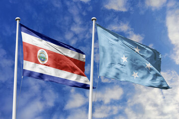 Costa Rica and Micronesia flags proudly waving against a vibrant blue sky, symbolizing...