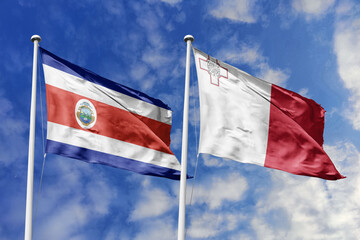 Costa Rica and Malta flags proudly waving against a vibrant blue sky, symbolizing international...