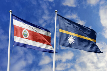 Costa Rica and Nauru flags proudly waving against a vibrant blue sky, symbolizing international...