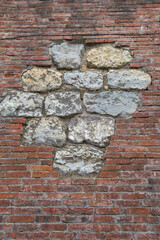Texture of weathered red brick wall in combination with old stone wall. Old brick and stone wall....