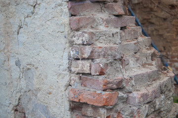 Texture of weathered red brick wall in combination with old stone wall. Old brick and stone wall....
